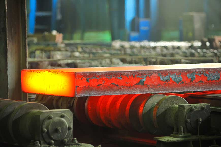 Hot rolled steel being processed in a steel mill